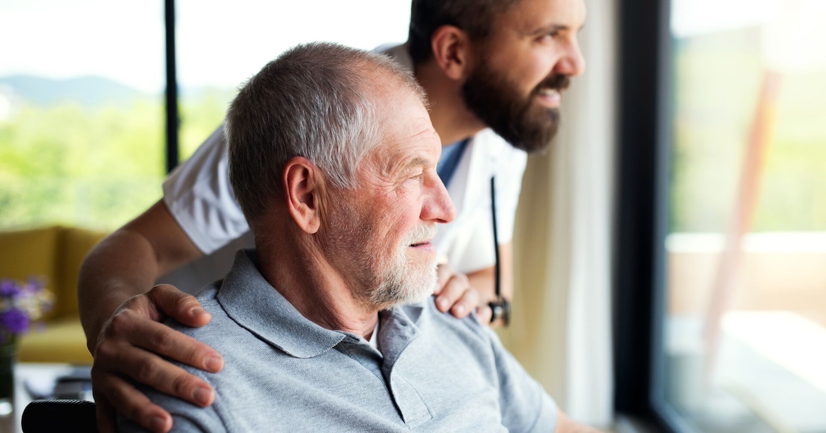 Person and a healthcare provider looking out a window