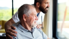Person and a healthcare provider looking out a window