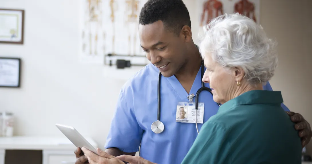 
  Healthcare provider showing a tablet to a patient
