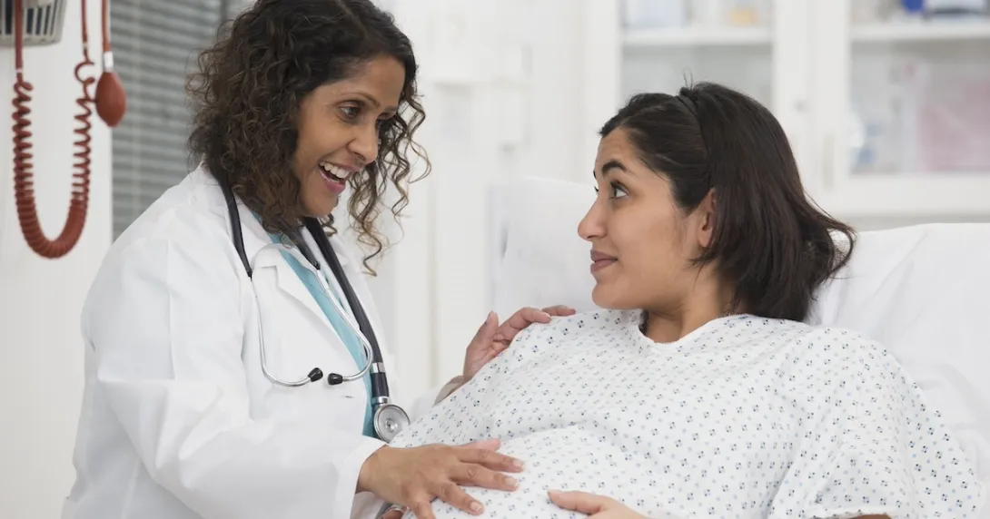 Healthcare professional consulting with pregnant patient
