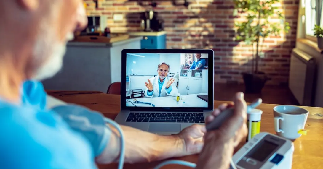 A patient talking to a doctor through a video chat on his computer while using a connected blood pressure device.
A patient talking to a doctor through a video chat on his computer while using a connected blood pressure device.