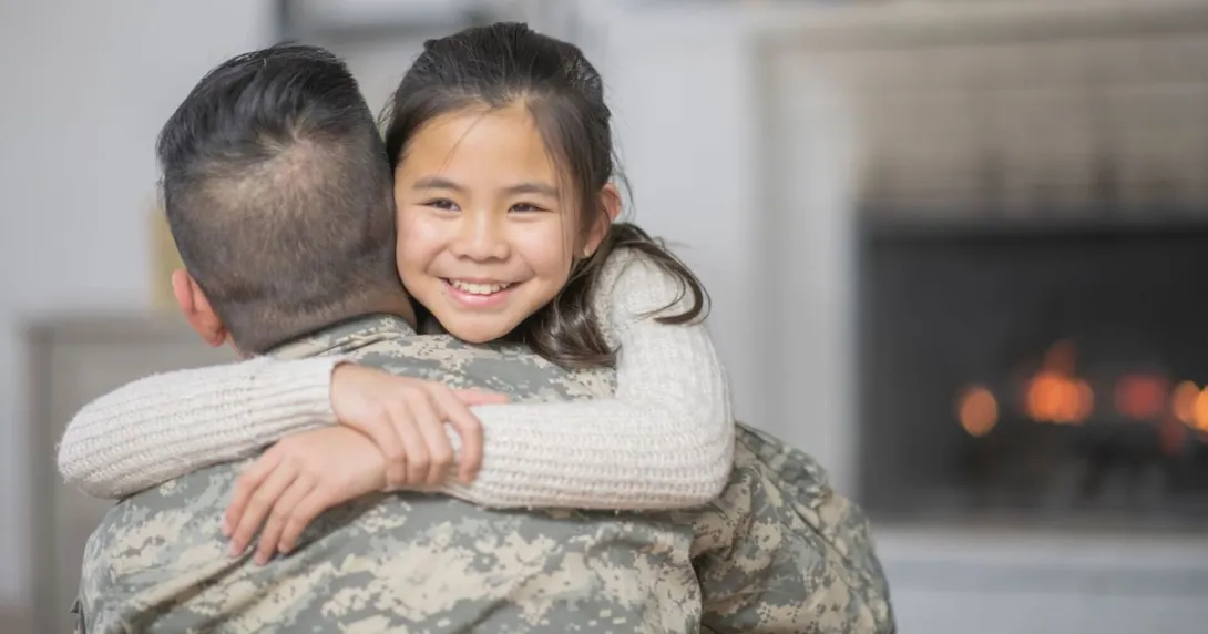 
  Veteran and a child hugging
