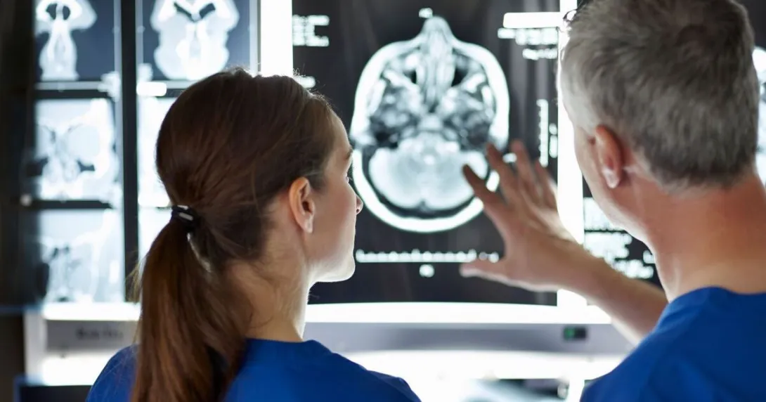 
  Surgeons analysing a brain scan.
