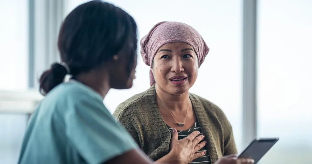 A woman with cancer is consulting her doctor.
