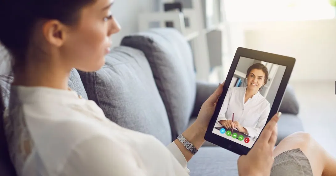 A woman talking to a provider using her tablet.