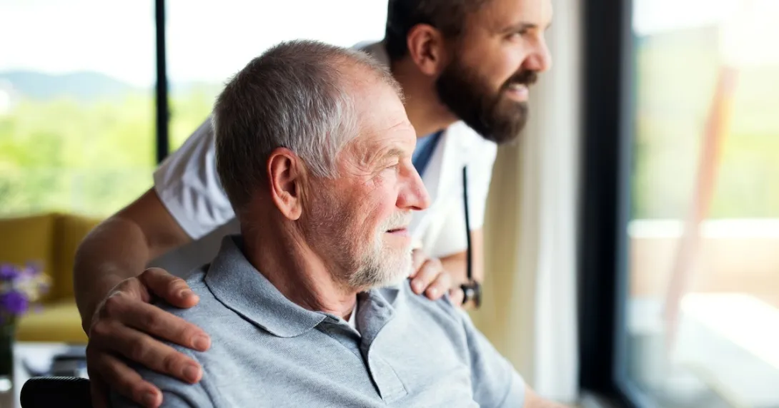 Person and a healthcare provider looking out a window
